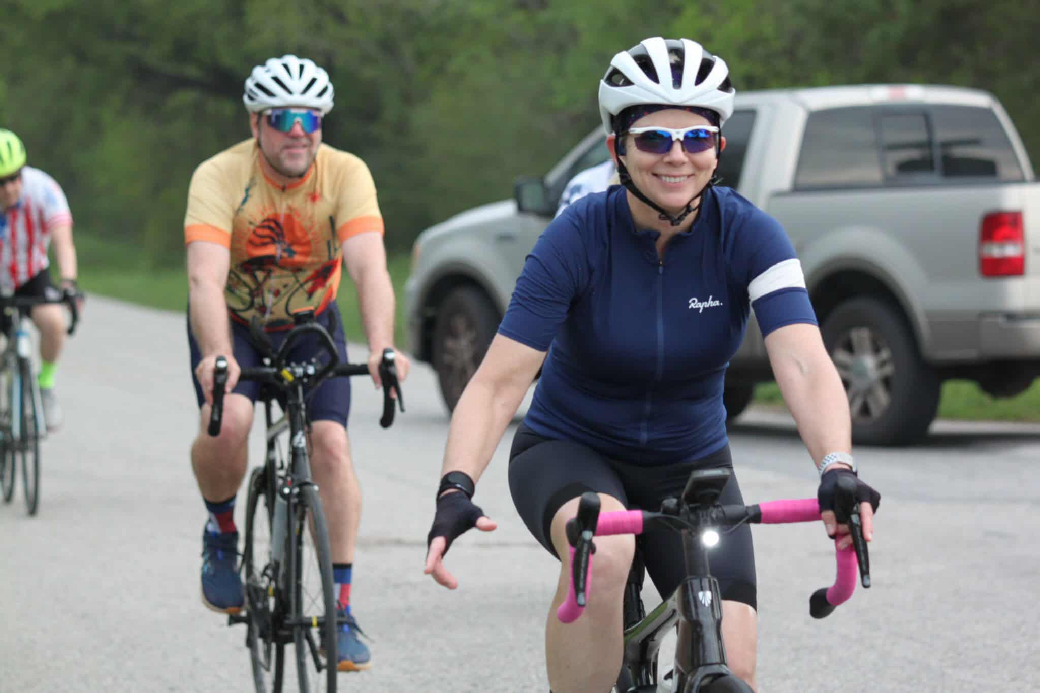 Bright woman cyclist enjoying the Bluebonnet Express ride, scenic outdoor trail, cycling adventure, Texas biking event, smiling rider.