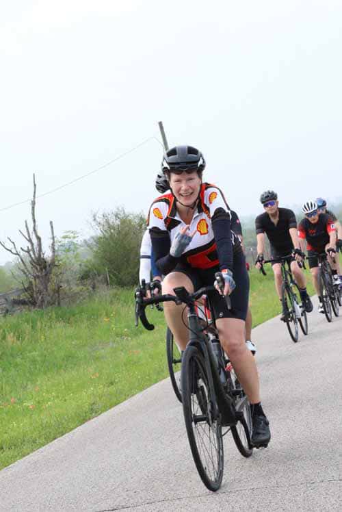 Bright cyclist enjoying Bluebonnet Express scenic trail ride on a sunny day.