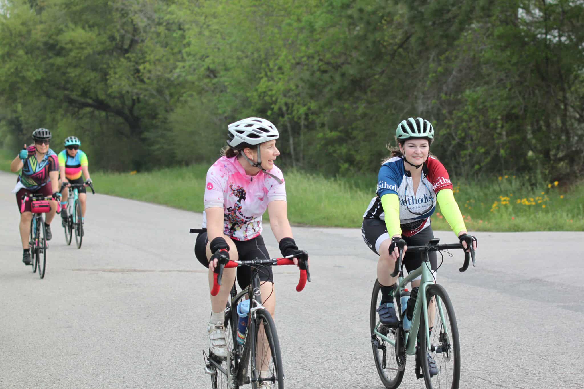 Bicycle team riding along scenic park trail for fitness and outdoor recreation.