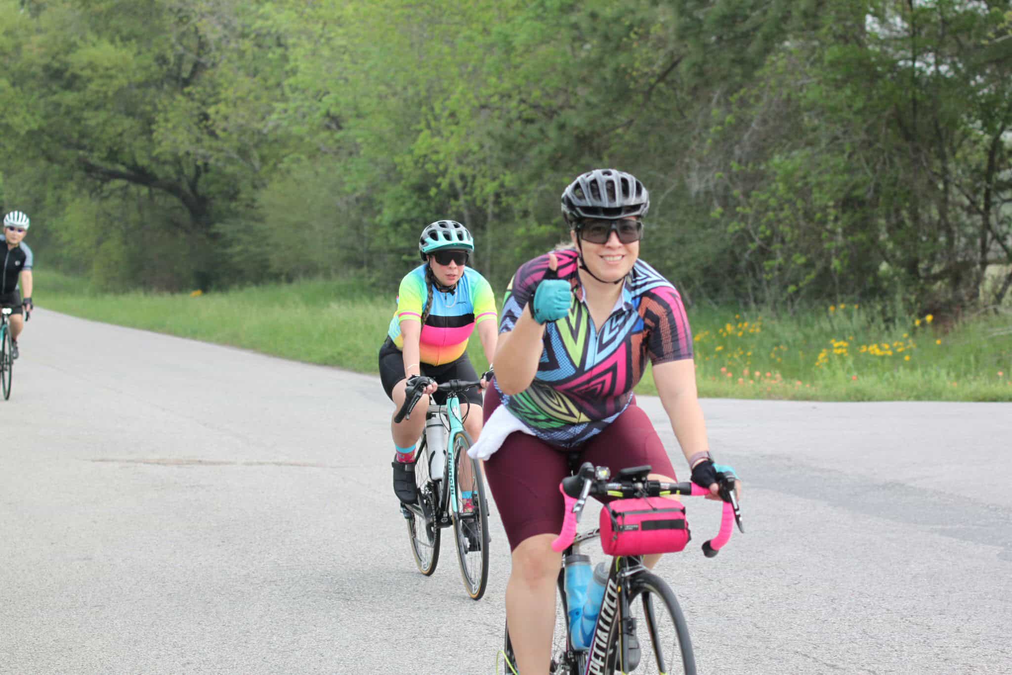 Vibrant women cycling group enjoying outdoor ride on scenic bike trail.