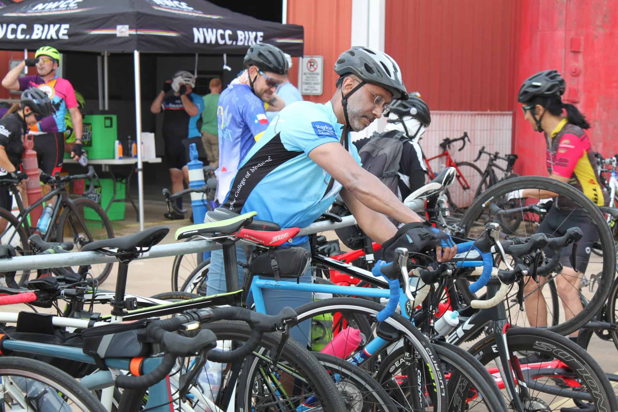 Brightly dressed cyclists preparing for a race at Bluebonnet Express event, showcasing competitive biking in Texas.