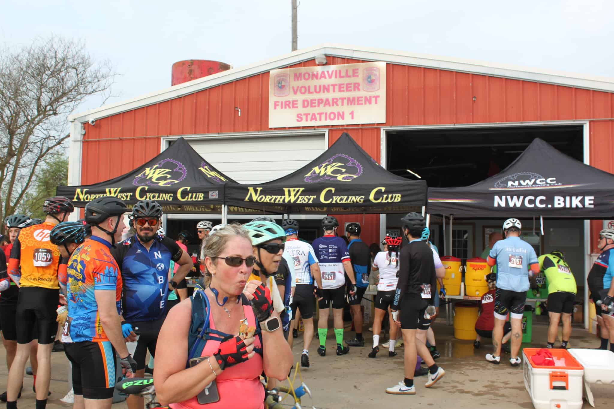 Colorful cyclists at NorthWest Cycling Club event outside Monaville Volunteer Fire Department station.
