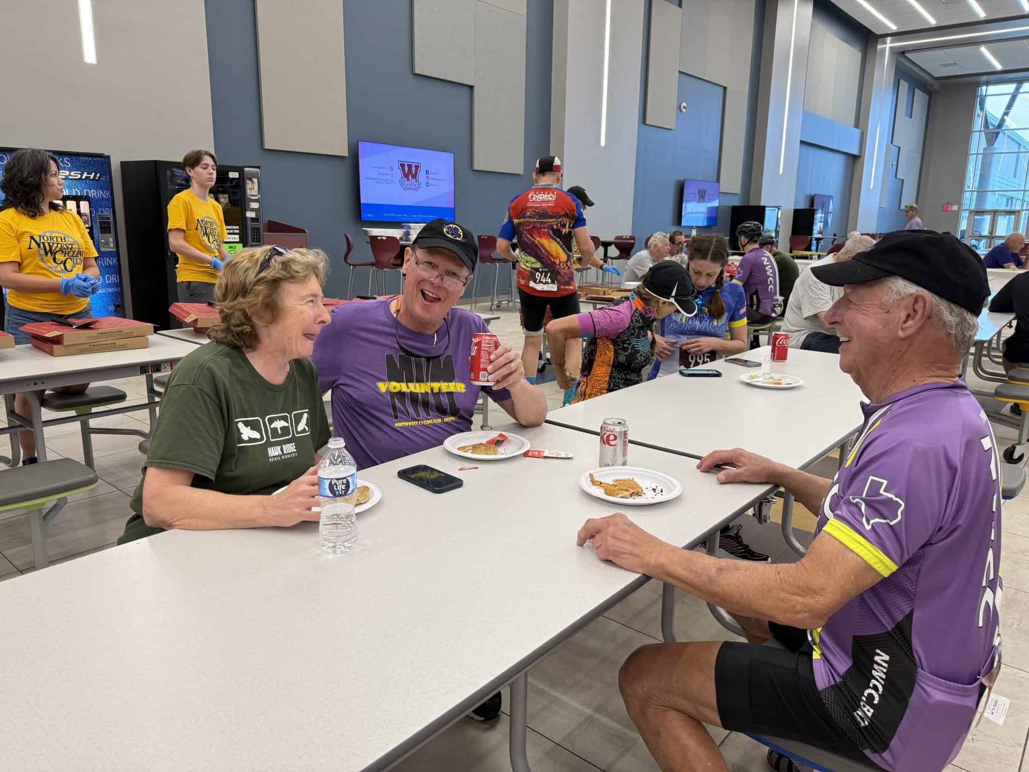 Happy cyclists enjoying breaks at Bluebonnet Express event, emphasizing community and cycling support.
