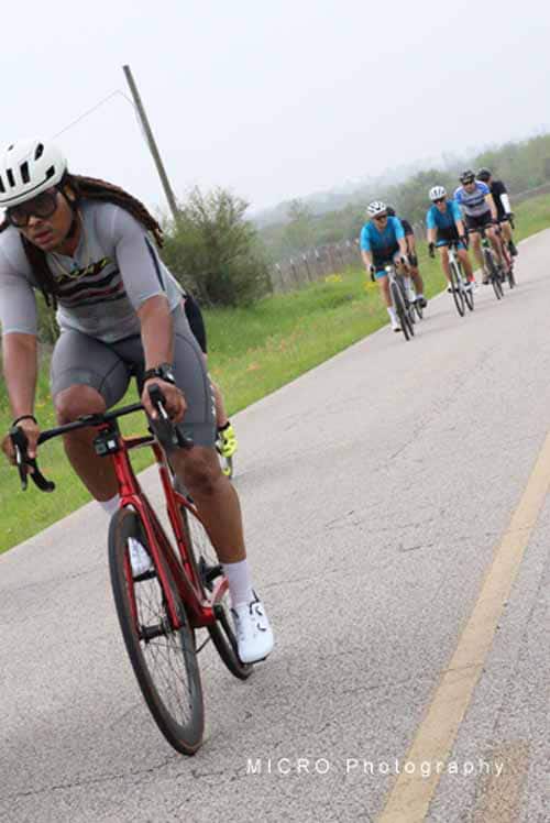 Riders on the road enjoying a group bike ride with Bluebonnet Express on scenic routes.