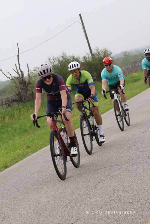 1. Bikers riding together on a scenic outdoor trail during daytime.