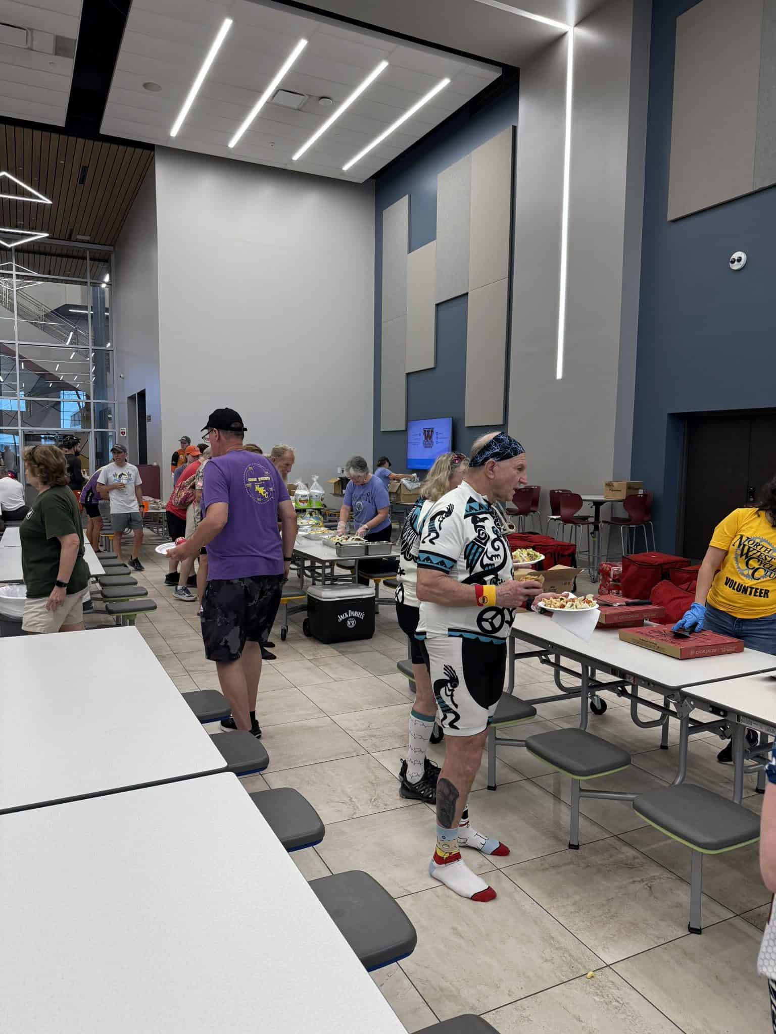 Bright indoor event at Bluebonnet Express with people enjoying food and community.