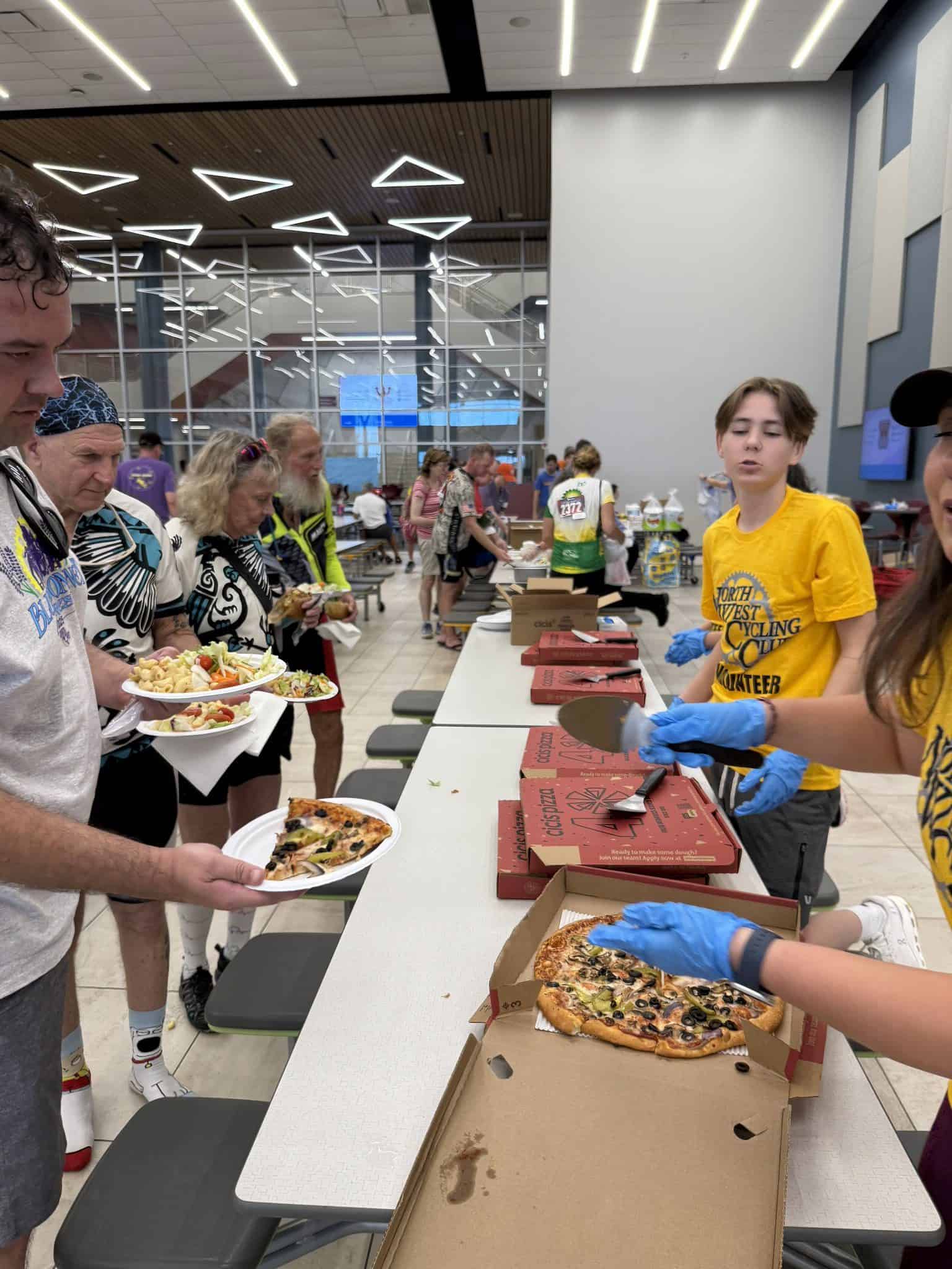 Freshly made pizza served at Bluebonnet Express event, highlighting community support and food choices.