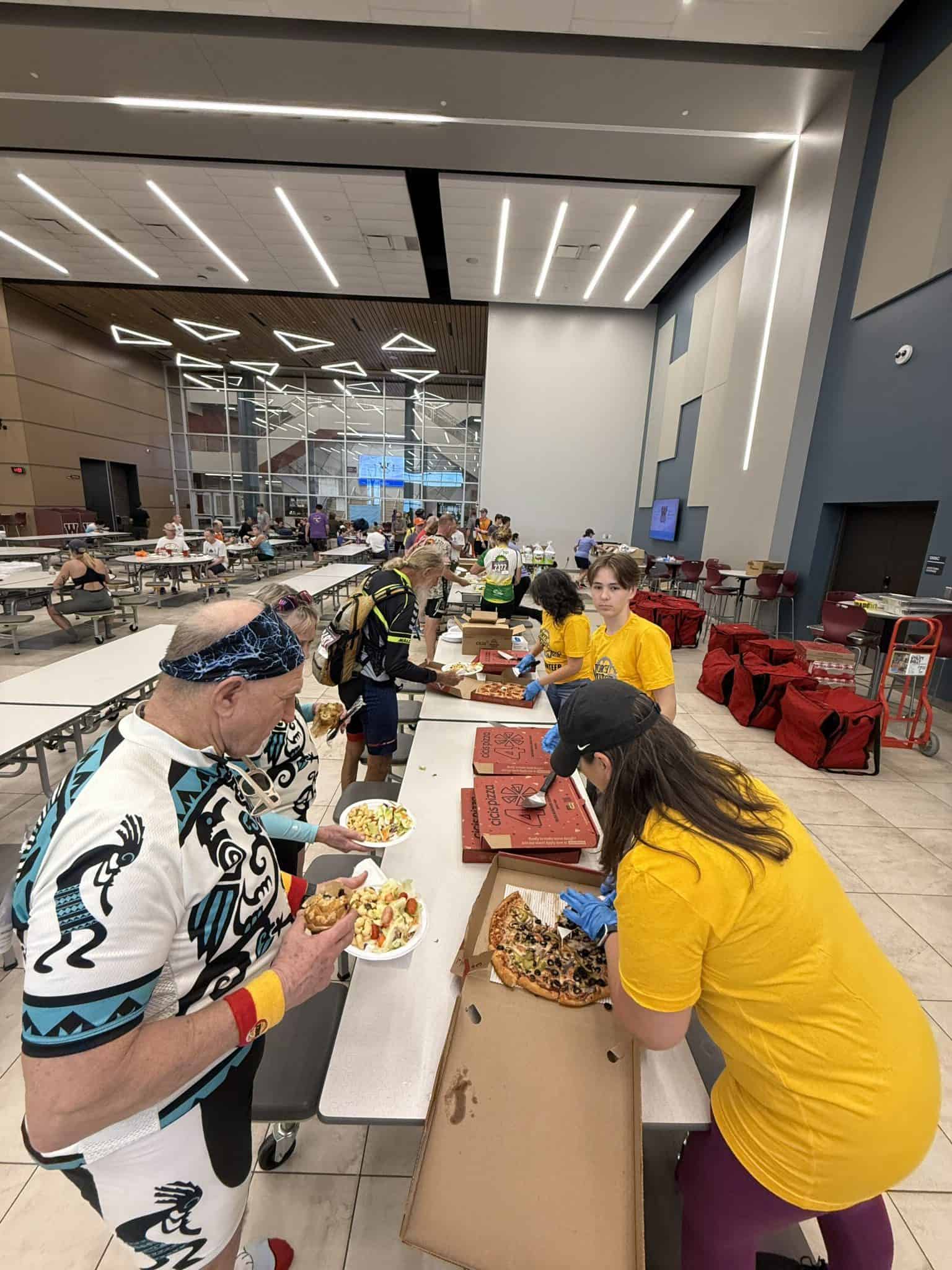 Freshly served pizza at Bluebonnet Express food station in a modern, bustling indoor setting.