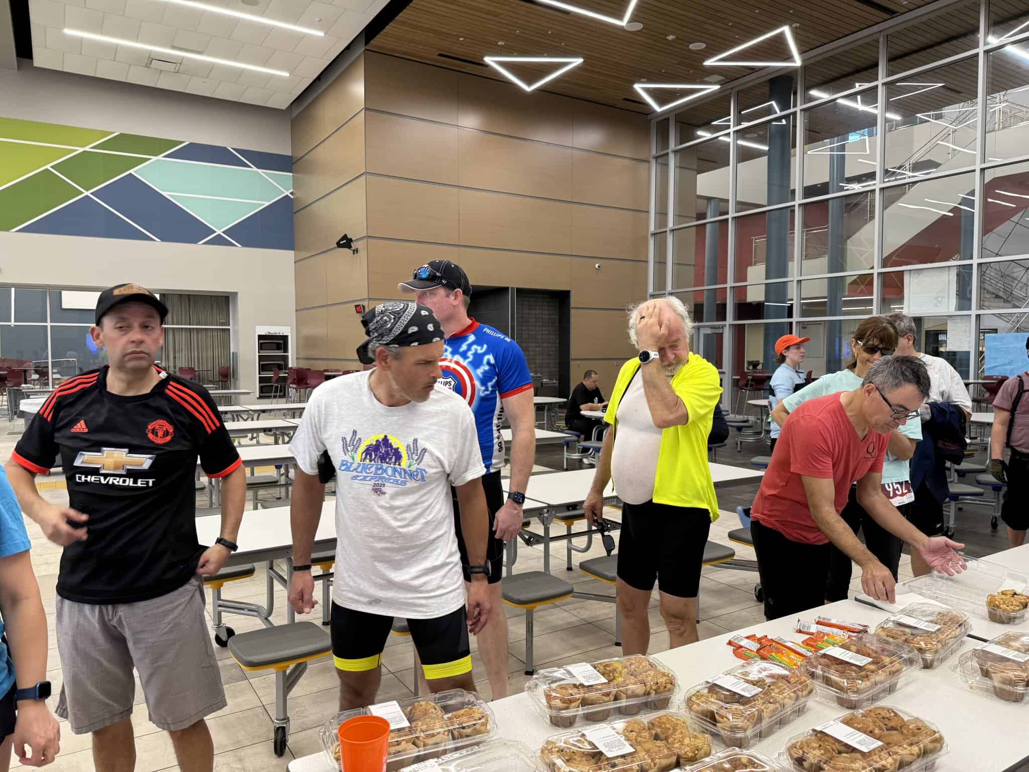 Stylish indoor space with cyclists enjoying pre-ride snacks at Bluebonnet Express event.