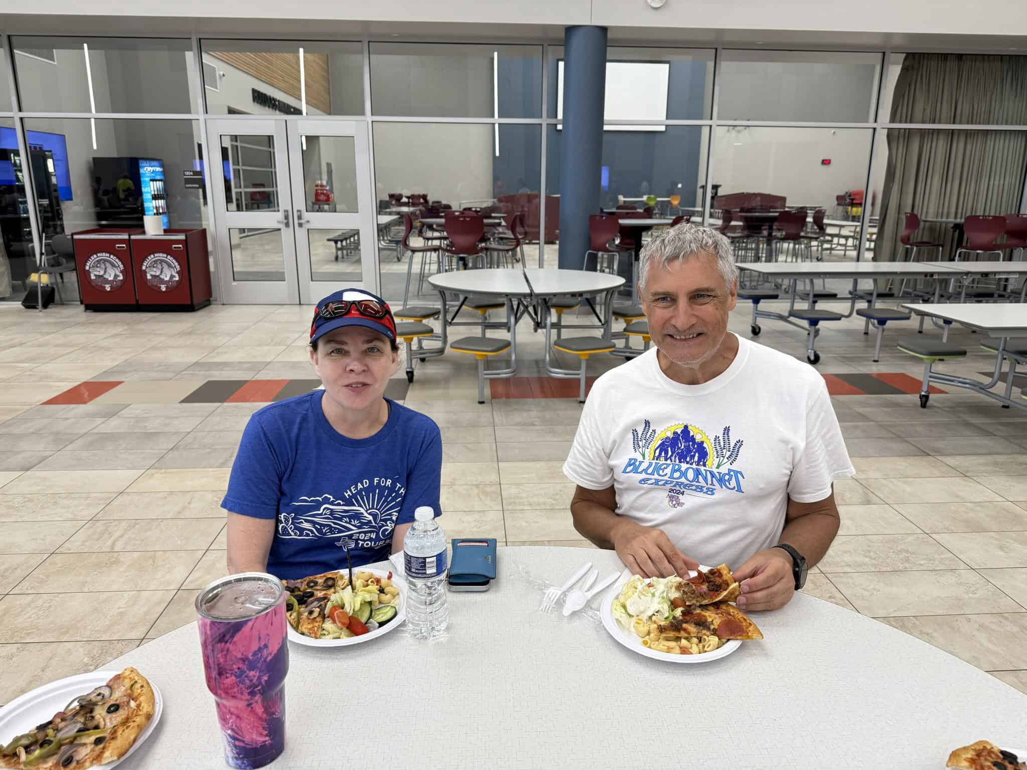 Delicious pizza and salads enjoyed by cyclists after a Bluebonnet Express ride at a dining hall.