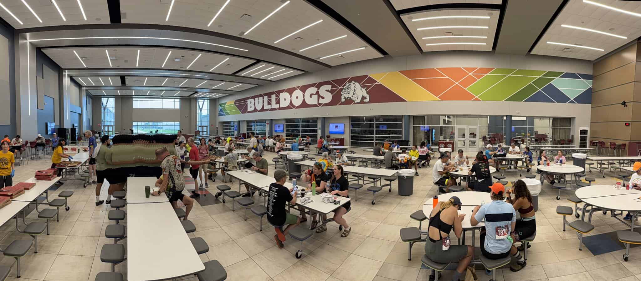 Bright indoor dining area at Bluebonnet Express, home to the Bulldogs, with many people enjoying meals and socializing.