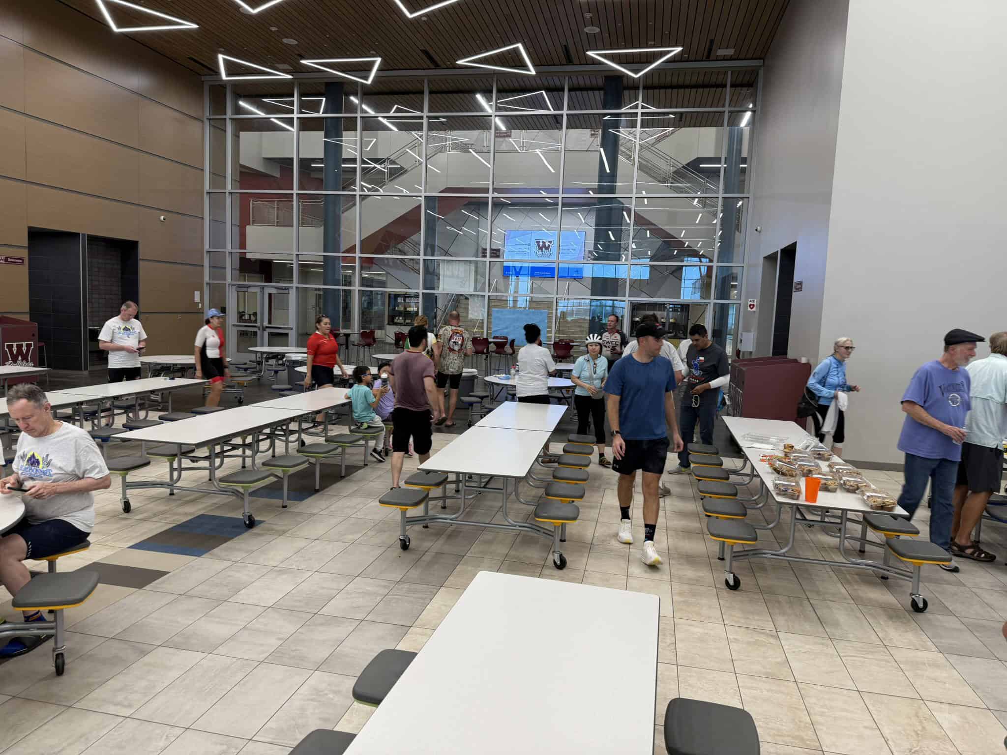 Bright, modern indoor dining area at Bluebonnet Express with people enjoying meals and socializing on campus.