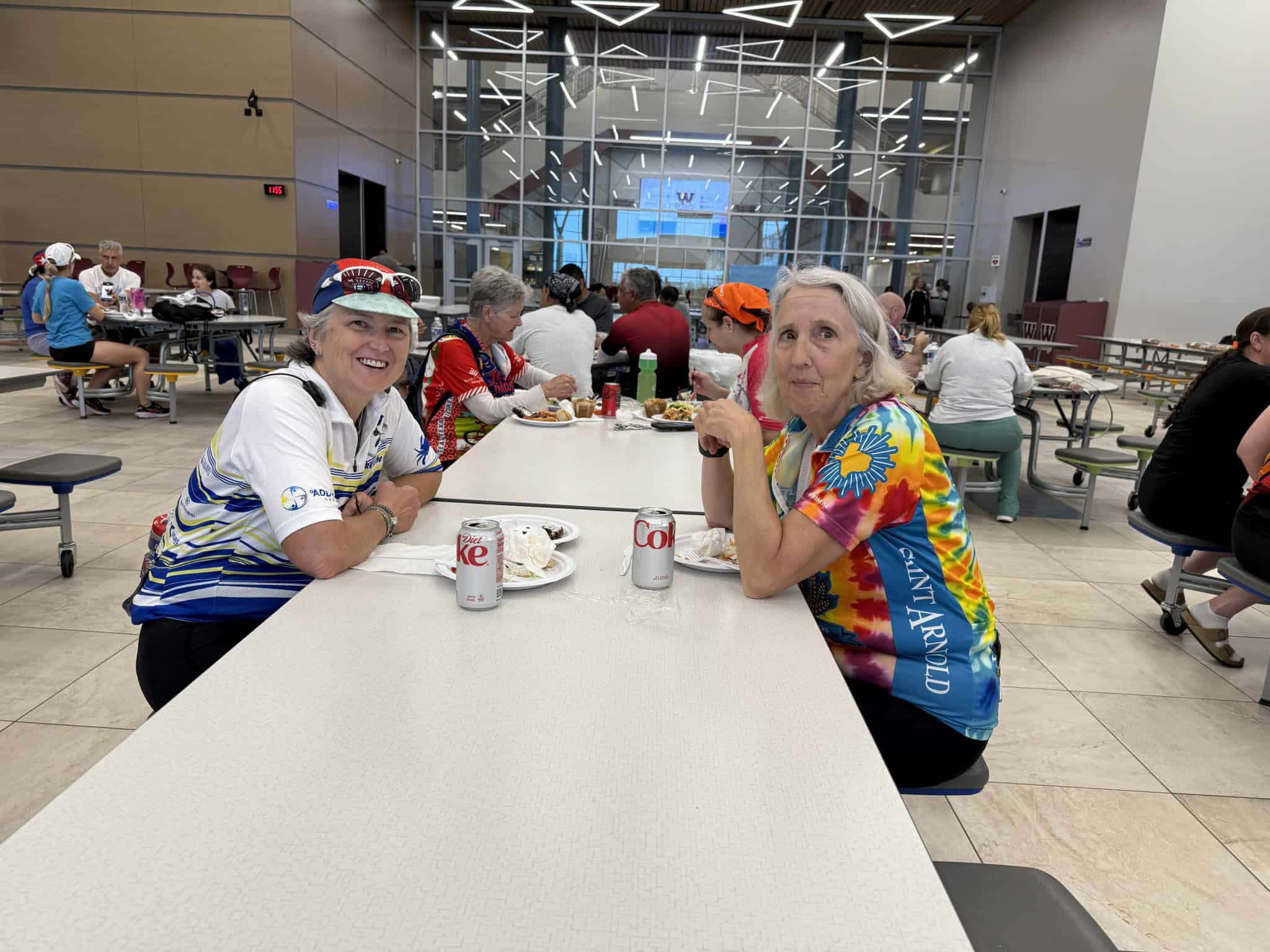 Brightly colored cyclists enjoying meals at Bluebonnet Express café, a popular stop for cycling enthusiasts in Texas.