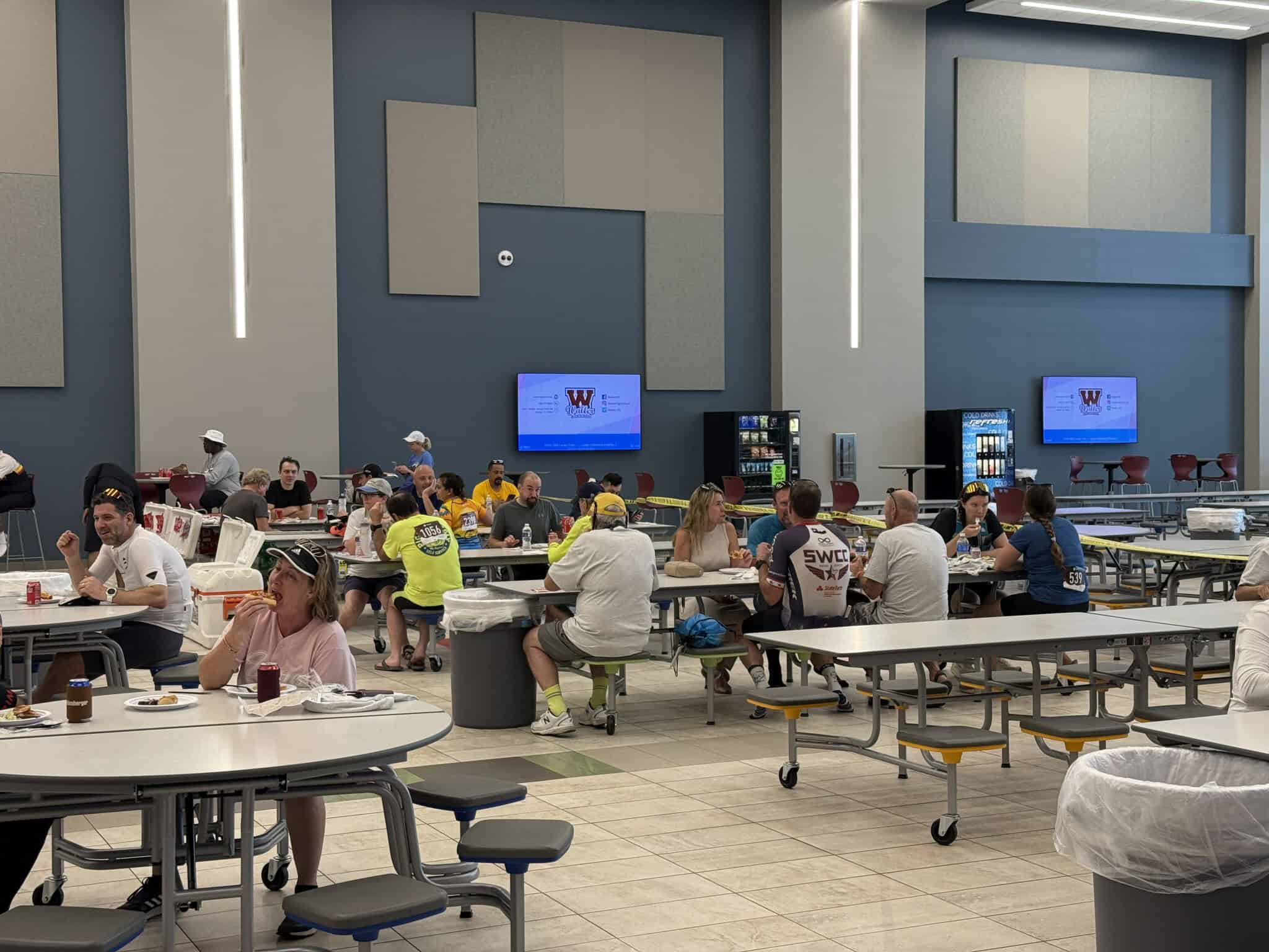 Bright cafeteria at Bluebonnet Express event with diverse attendees and modern decor.