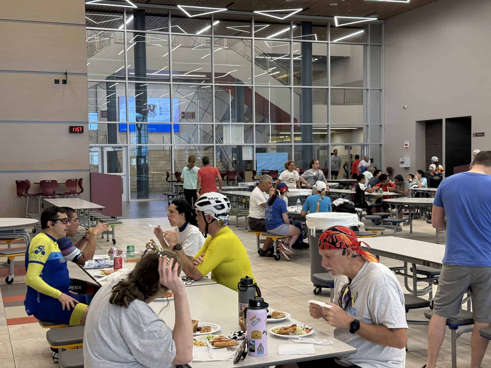 Bright indoor dining area at Bluebonnet Express, featuring diverse guests enjoying meals in a modern, well-lit environment.