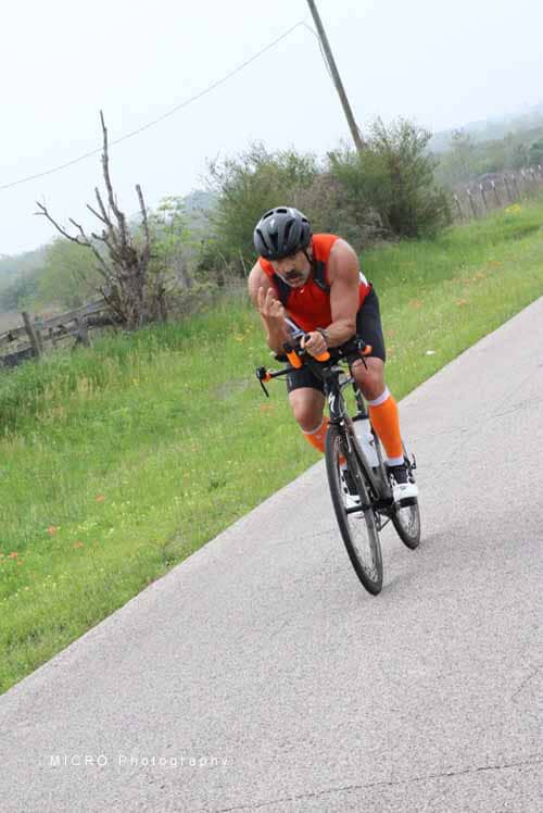 Vigilant cyclist on racing bike with helmet during Bluebonnet Express event in Texas.