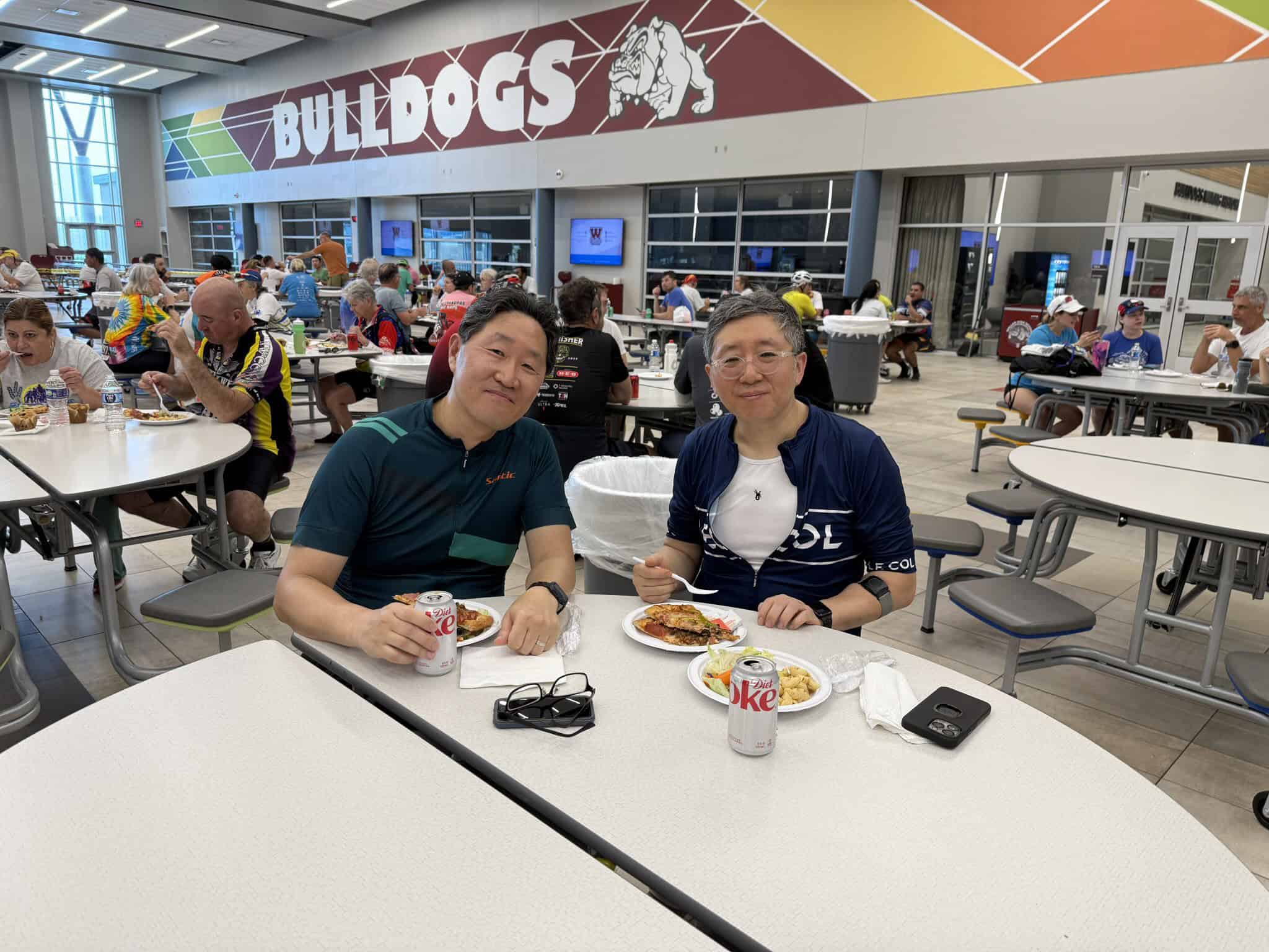 Celebrating after a biking event at Bluebonnet Express with friends inside a bustling cafeteria.