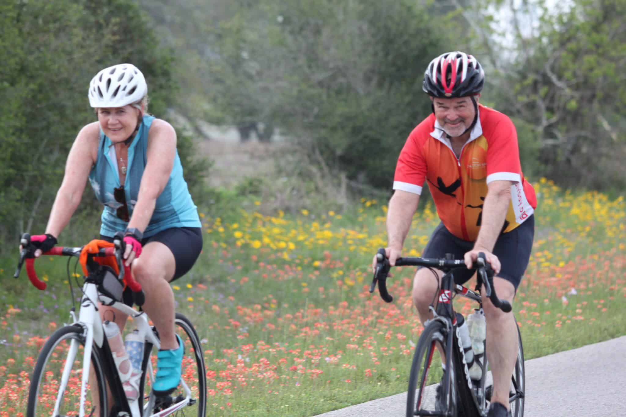Enjoying a scenic bike ride with Bluebonnet Express, surrounded by vibrant wildflowers and lush greenery.