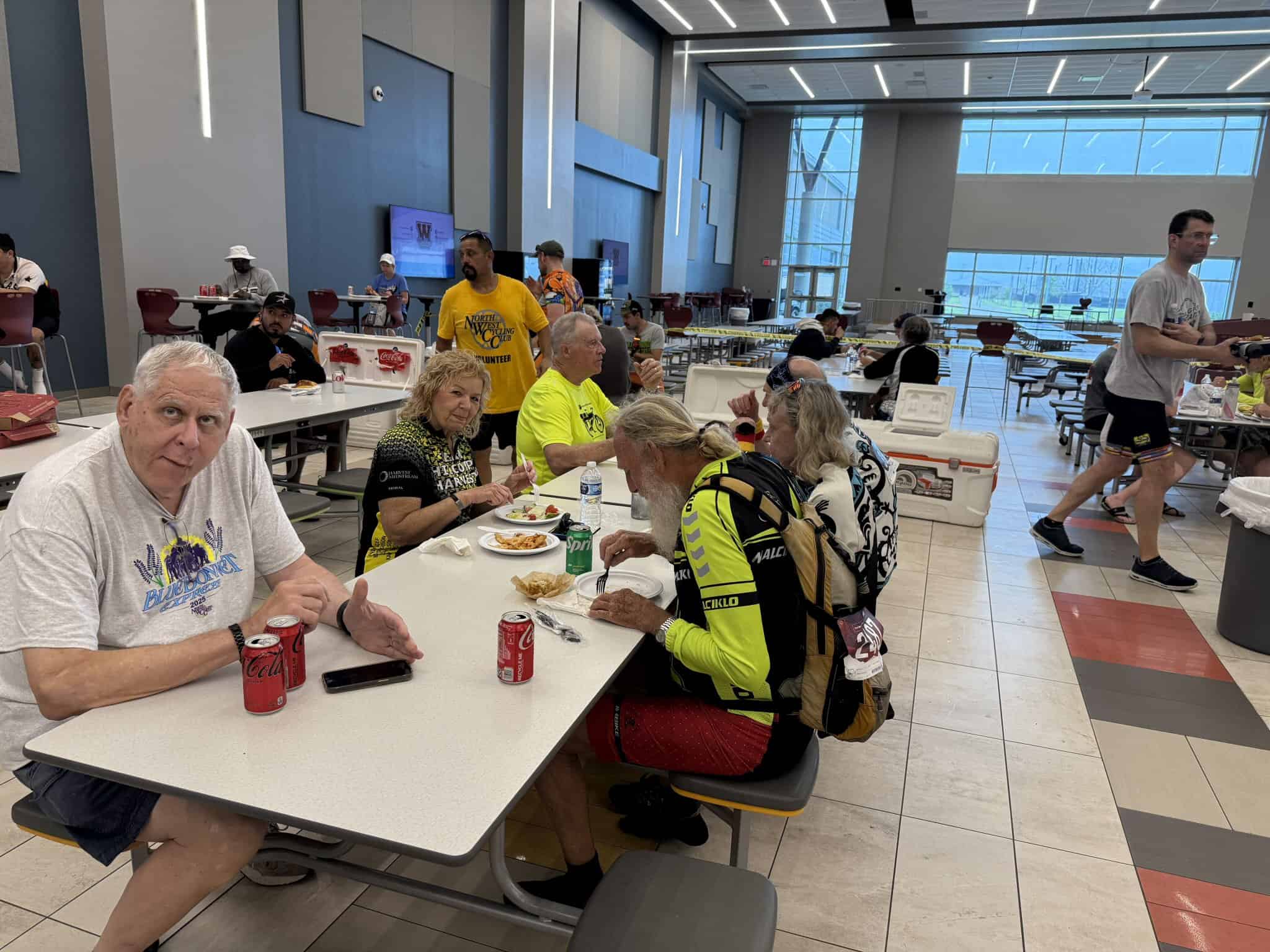 Refreshing lunch at Bluebonnet Express cycling event, featuring cyclists and supporters enjoying a meal together.