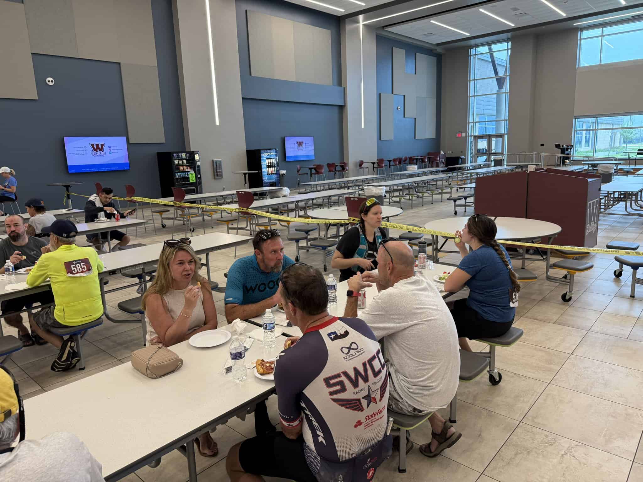Bright indoor dining area at Bluebonnet Express with people enjoying meals and conversations.