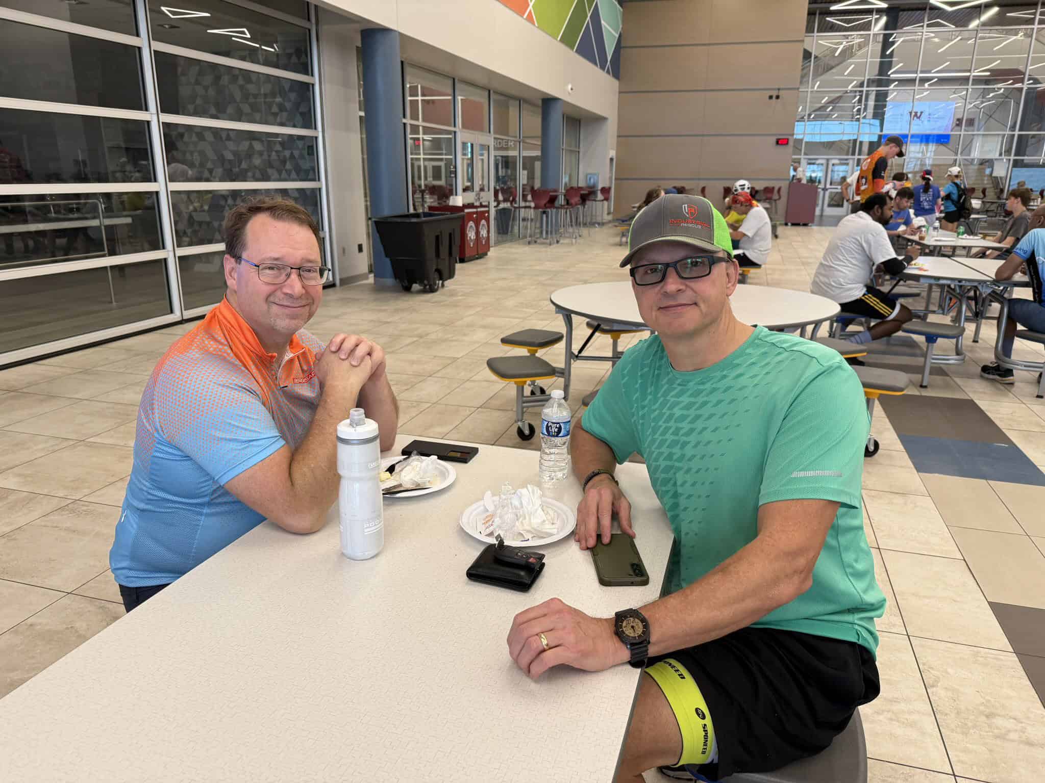 Men enjoying a break at Bluebonnet Express café, cycling enthusiasts refueling.