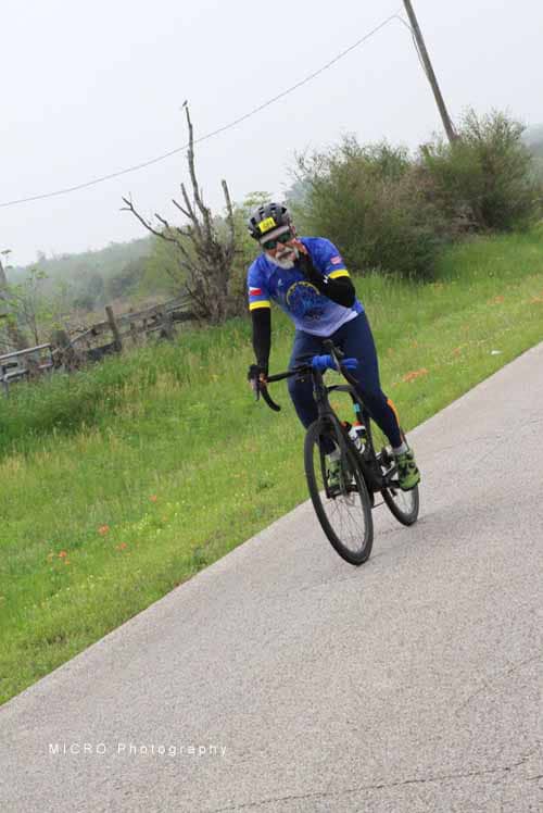 Optimized Alt Text: Cyclist riding on scenic outdoor bike trail in blue jersey and helmet.