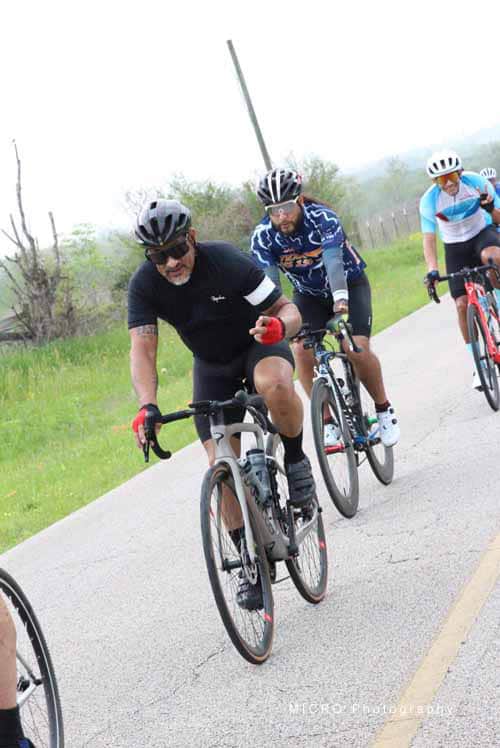 Brightly colored cyclists riding on a scenic trail during a Bluebonnet Express event.