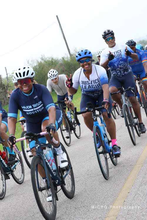 Brightly colored cyclists riding during Bluebonnet Express cycling event, promoting charity and community wellness.
