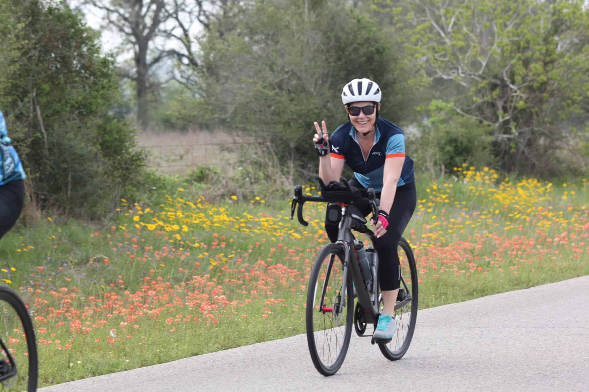 Vibrant cycling in blooming spring landscape with smiling woman on electric bike.