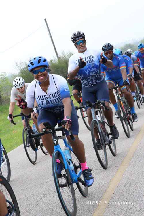 Brightly colored cyclists participating in the Bluebonnet Express charity bike ride on a scenic outdoor route.