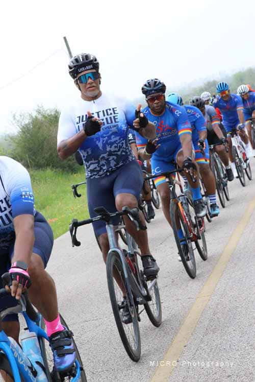 Brightly dressed cyclists racing in Bluebonnet Express cycling event, promoting healthy riding.