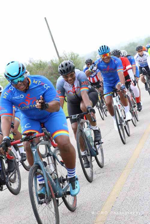1. Cyclists riding in Bluebonnet Express charity bike race with vibrant jerseys and helmets.