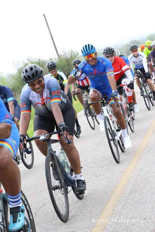 Vibrant group of cyclists participating in Bluebonnet Express bike race, showcasing teamwork and outdoor adventure.