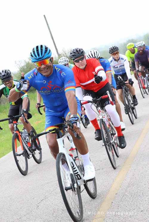 Vibrant group of cyclists riding together during the Bluebonnet Express cycling event.