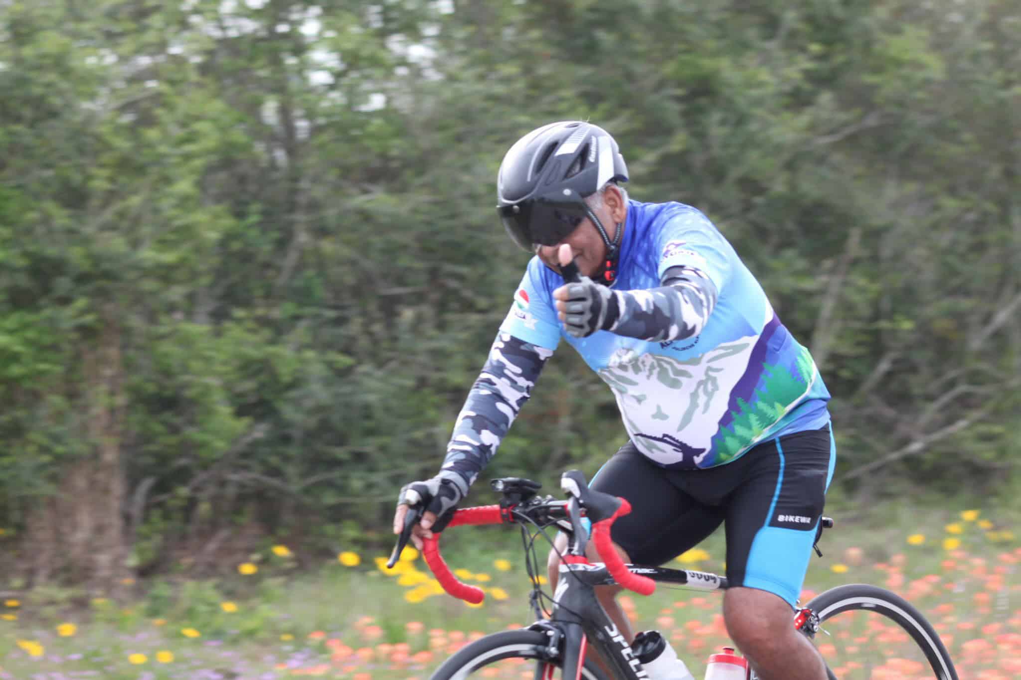 Vibrant cyclist riding through nature on Bluebonnet Express scenic bike trail.