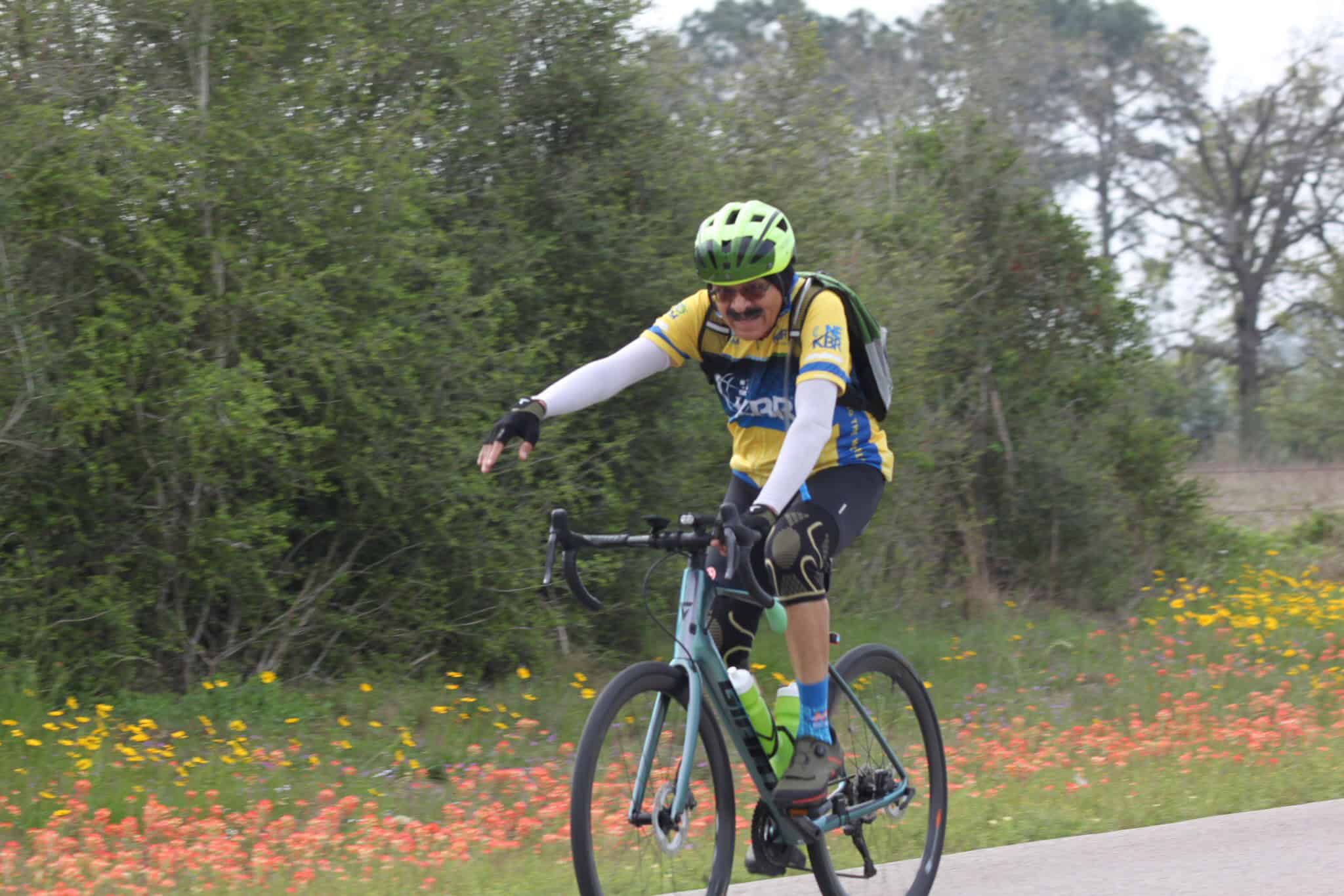 Vibrant cyclist riding a mountain bike along a scenic trail during spring.