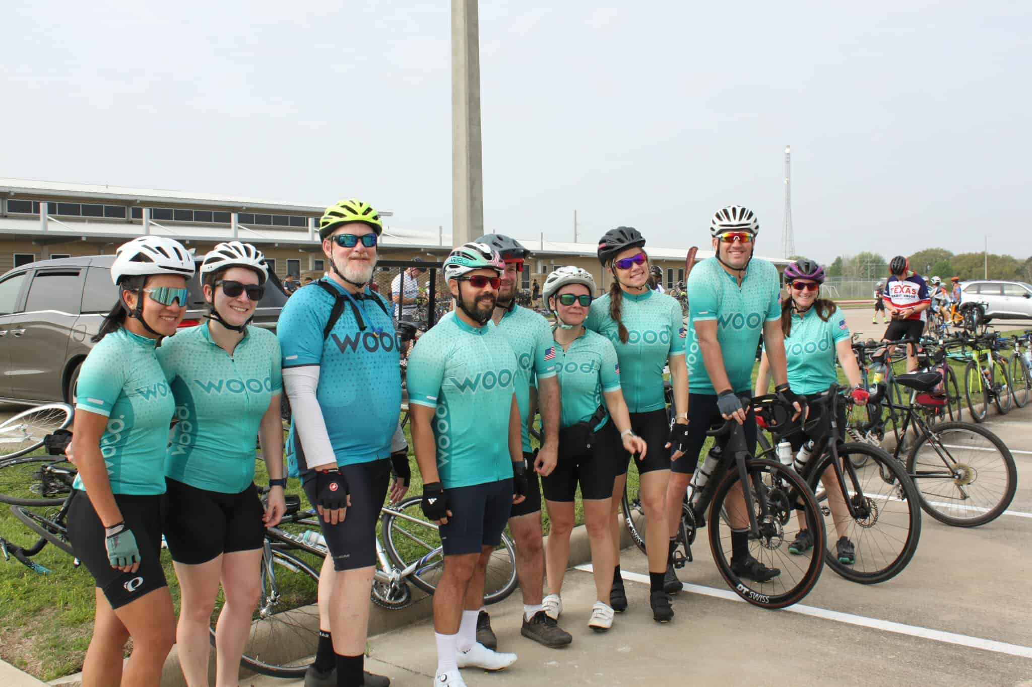 Vibrant cycling team in matching jerseys at Bluebonnet Express bike race event.