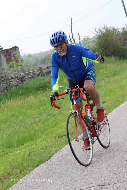 Enjoying a joyful bike ride on the Bluebonnet Express trail with scenic countryside views.