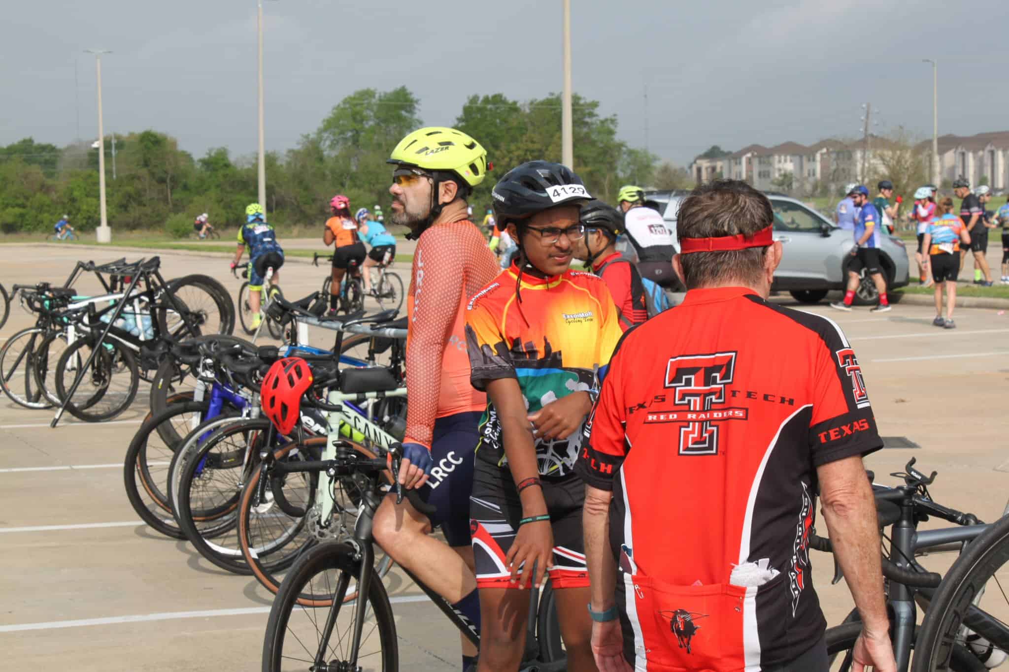 Road cycling event at Bluebonnet Express in Texas with cyclists preparing and parking bikes.