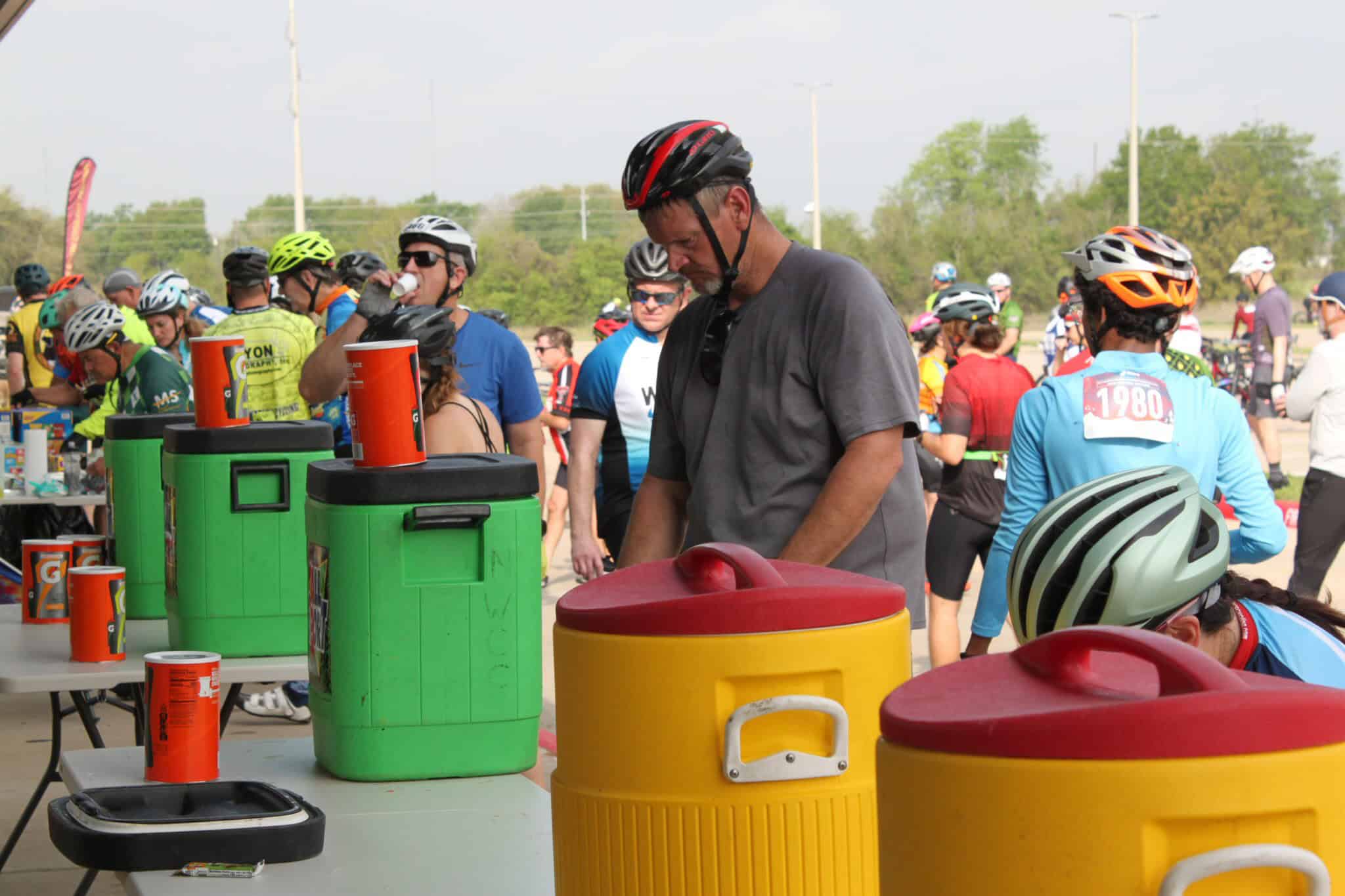 Brightly colored water coolers at Bluebonnet Express cycling event, providing hydration for participants.