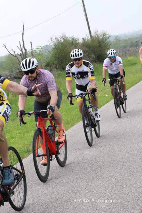 Active cyclists riding on a scenic rural road during Bluebonnet Express event.