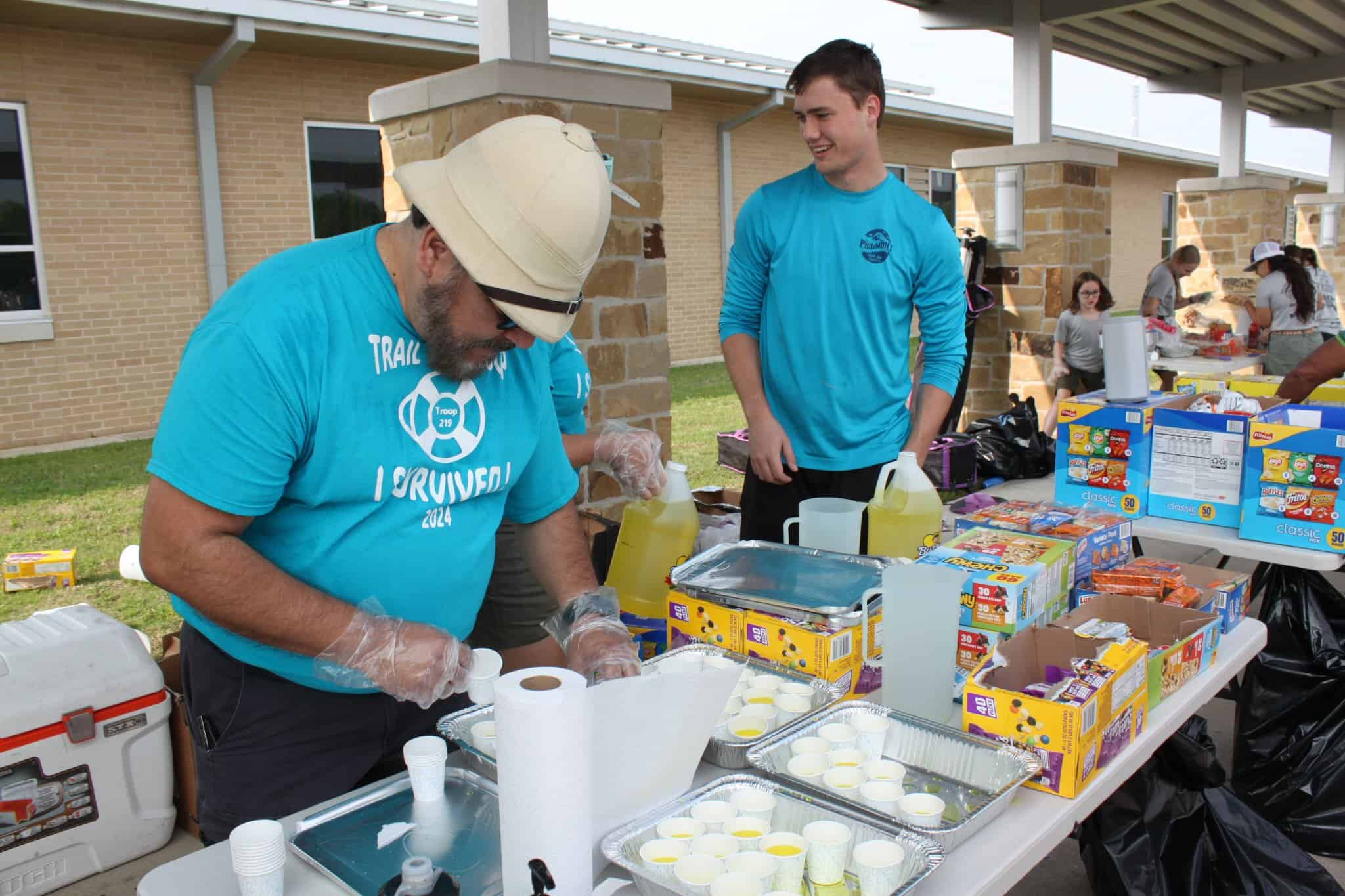 Refreshment station at Bluebonnet Express charity event, serving drinks and snacks.