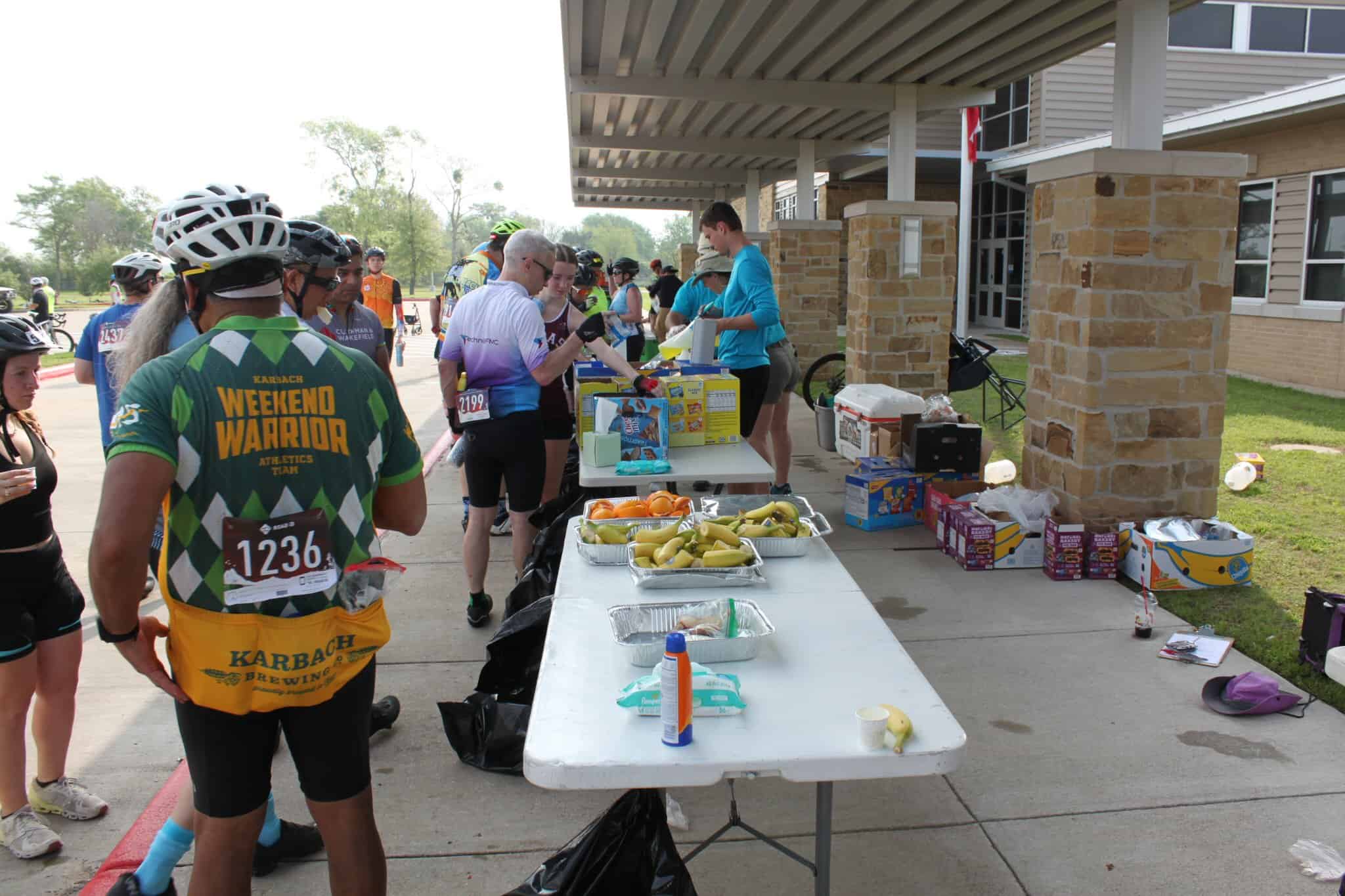 Refreshments station at Bluebonnet Express cycling event, offering fruits and snacks for riders.