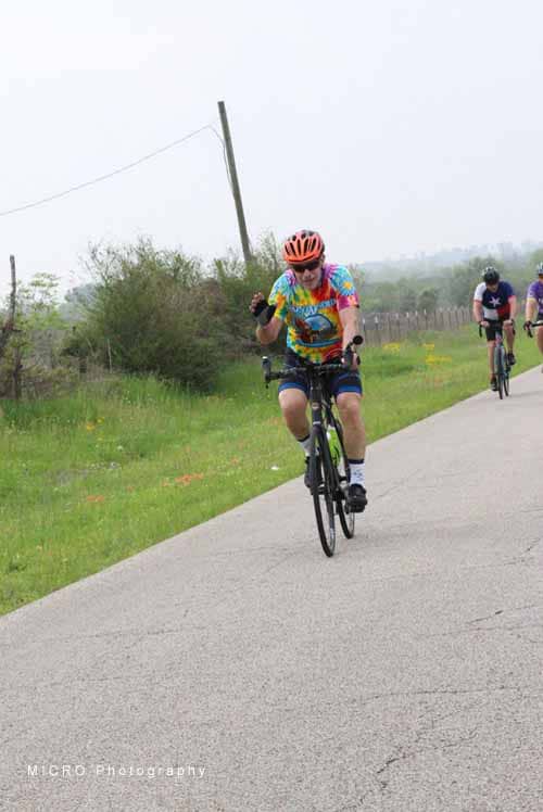 Brightly dressed cyclist enjoying a scenic ride along the Bluebonnet Express trail in Texas.