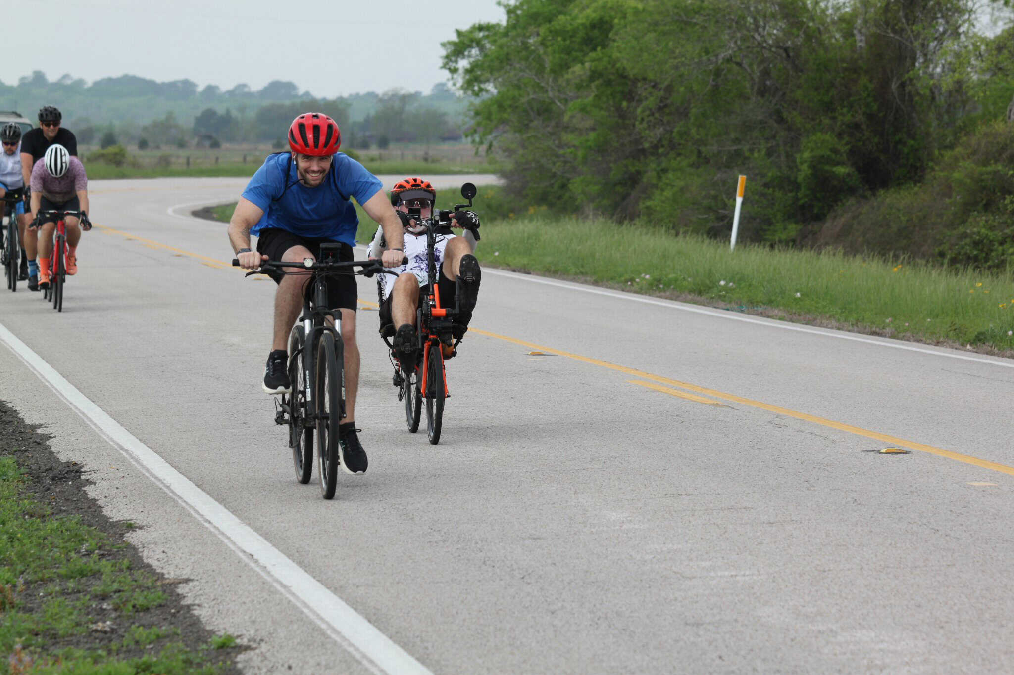 Family cycling during daylight on scenic rural road, emphasizing outdoor bike rides.