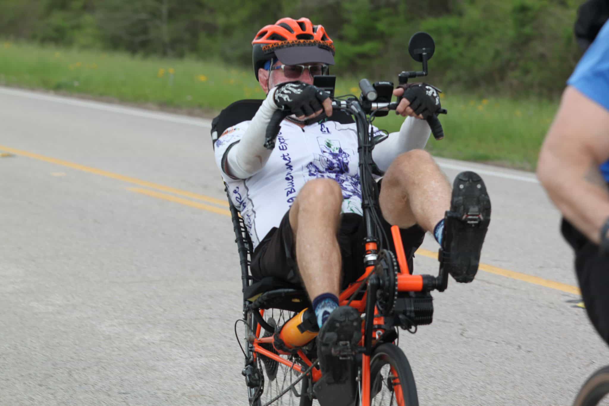 Adventure cycling on Bluebonnet Express trail with adaptive tricycle for disabled riders.