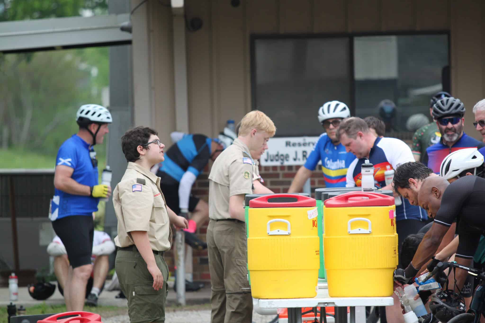 Cyclists refuel at Bluebonnet Express bike event, emphasizing community and hydration.