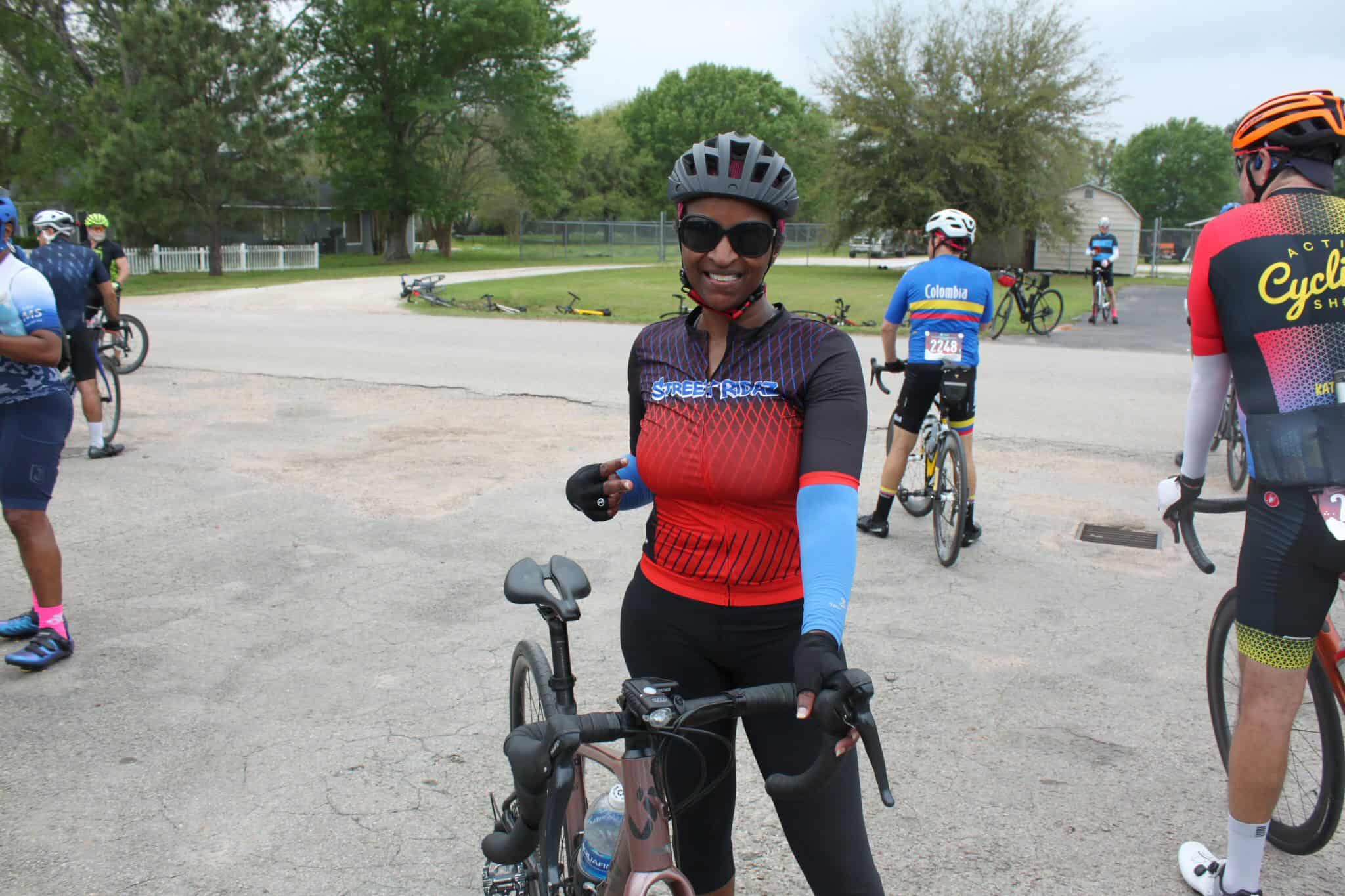 Vibrant cyclist smiling at Bluebonnet Express cycling event, supporting community bike ride and outdoor fitness.