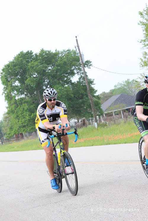 Cyclist riding a bike during Bluebonnet Express event in Texas, outdoor scene.