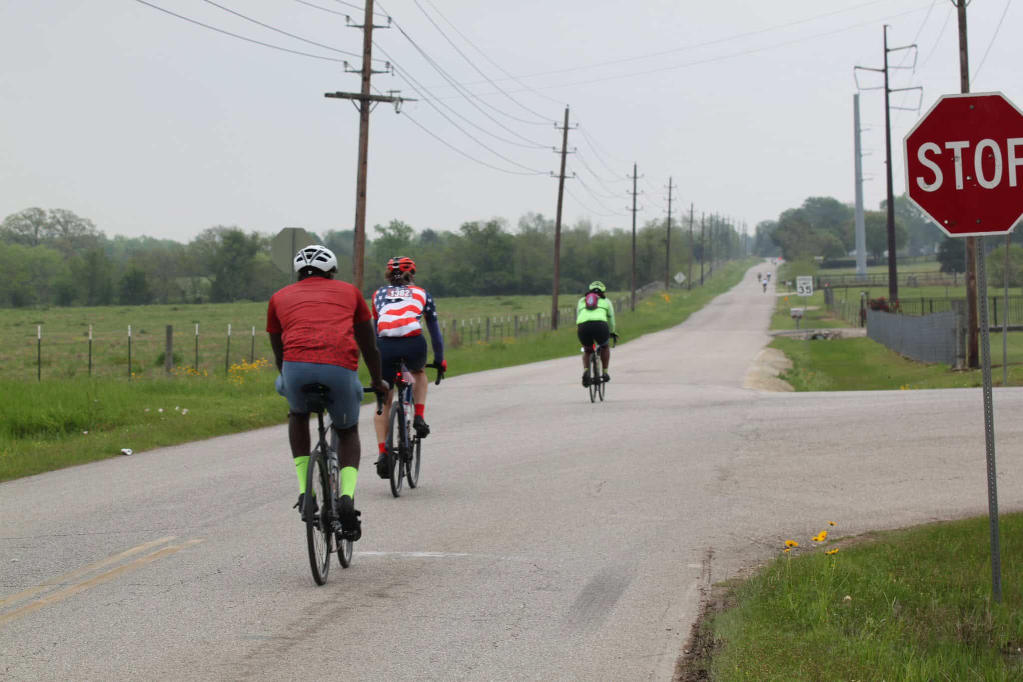 Bicycle riders on a rural road, promoting eco-friendly transportation with Bluebonnet Express.